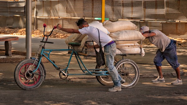 Men pushing bike Jim Robellard